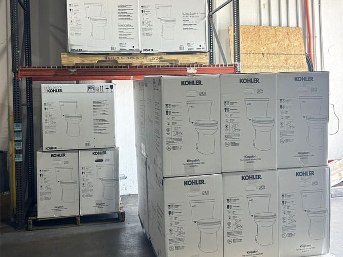 Kohler Toilets stacked in the Cowan Supply Forest Park plumbing warehouse