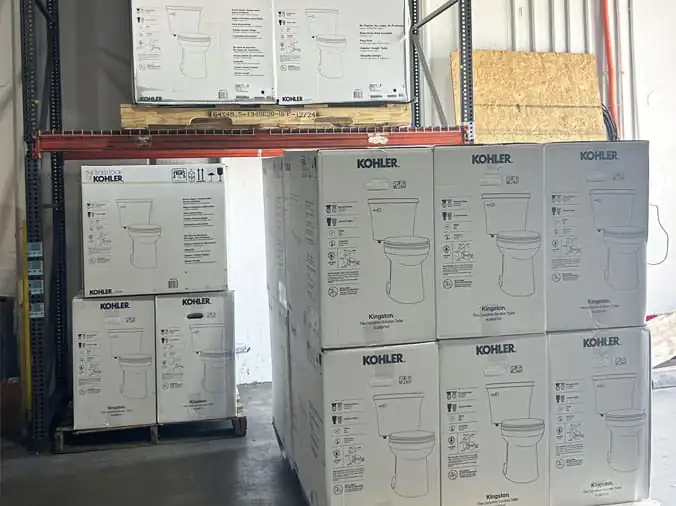 Kohler Toilets stacked in the Cowan Supply Forest Park plumbing warehouse